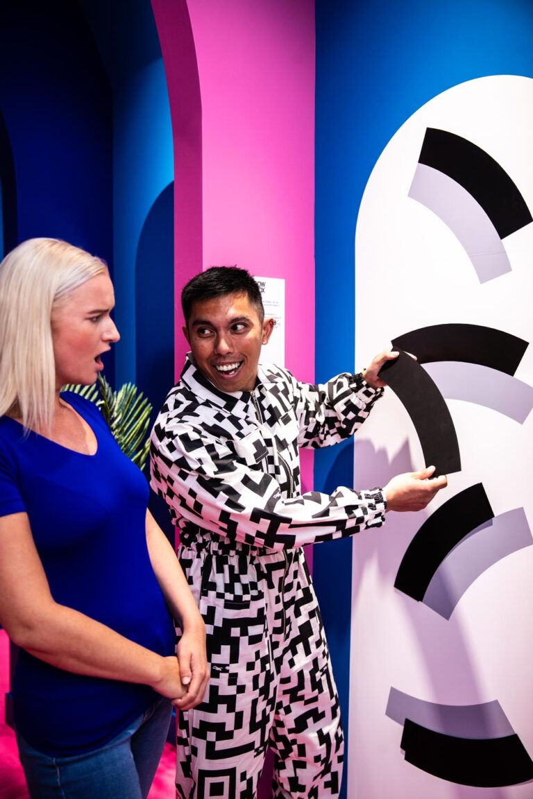 Two people enjoying an exhibit at Paradox Museum during a group event.